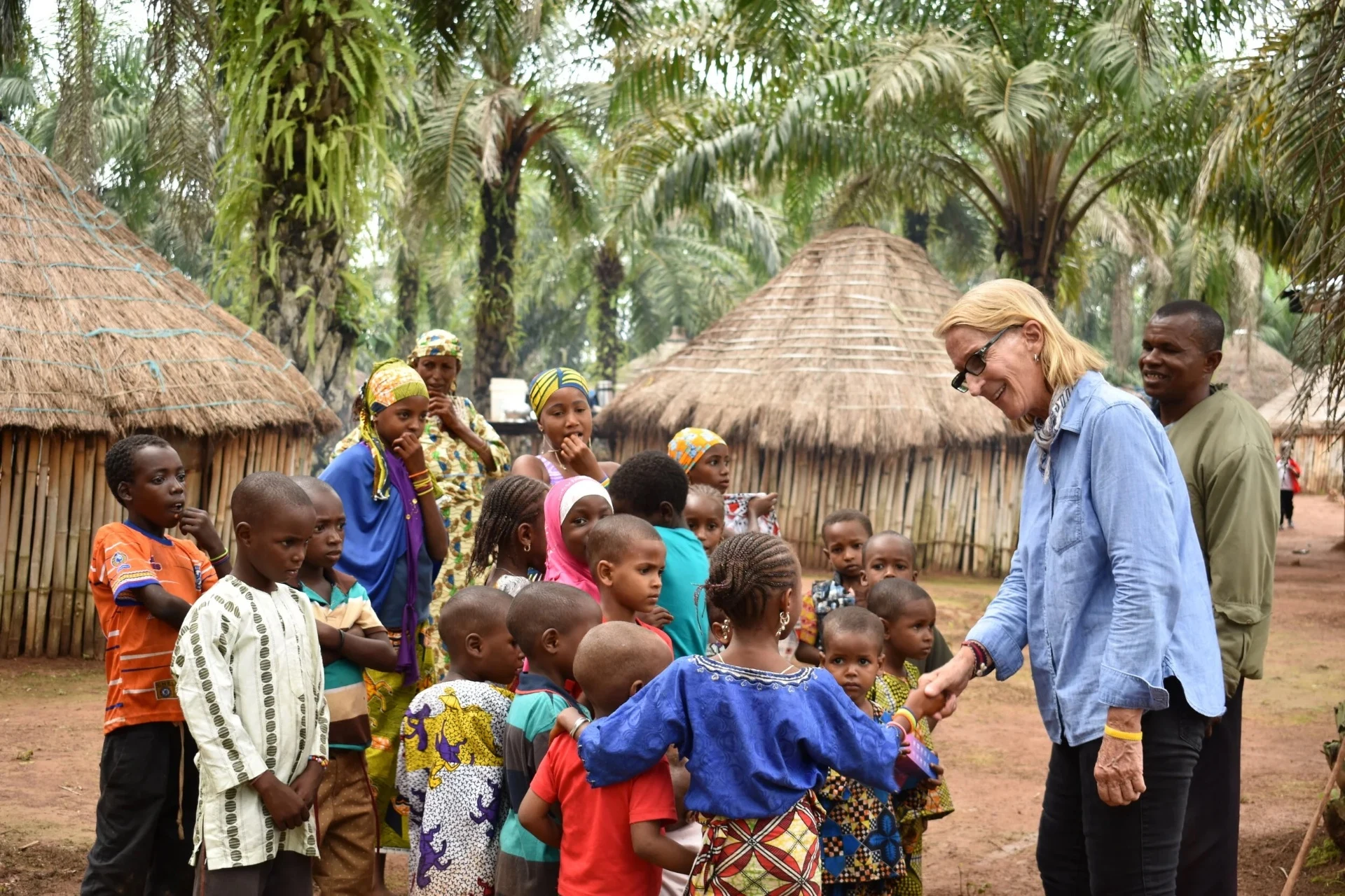 Phyllis greeting children in a Nigerian village