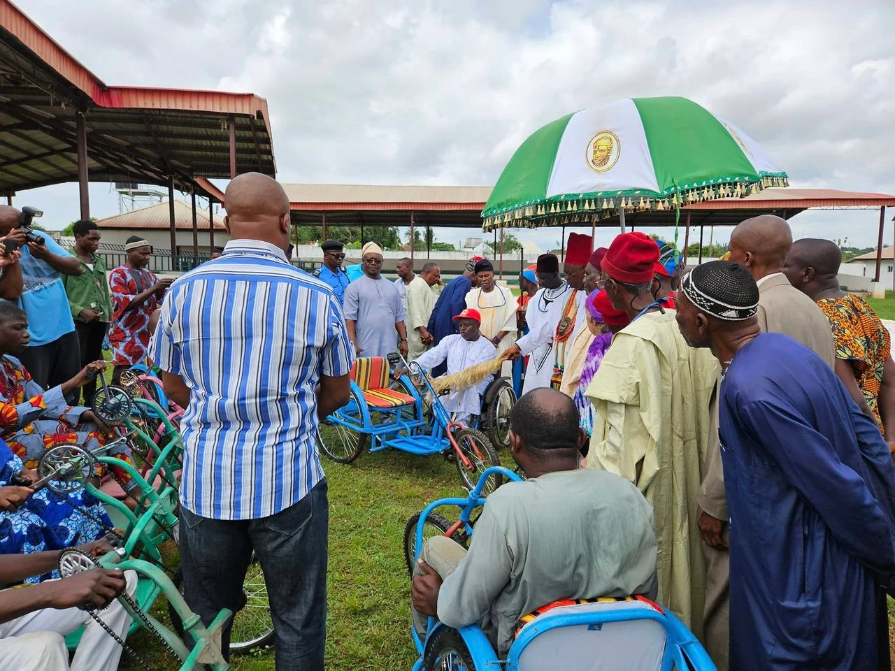 Wheelchair distribution ceremony with community